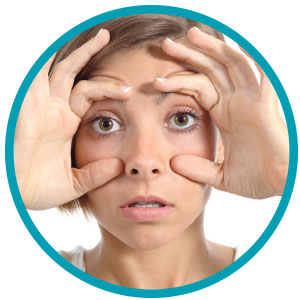 Image of student using their hands to try and keep their eyes open