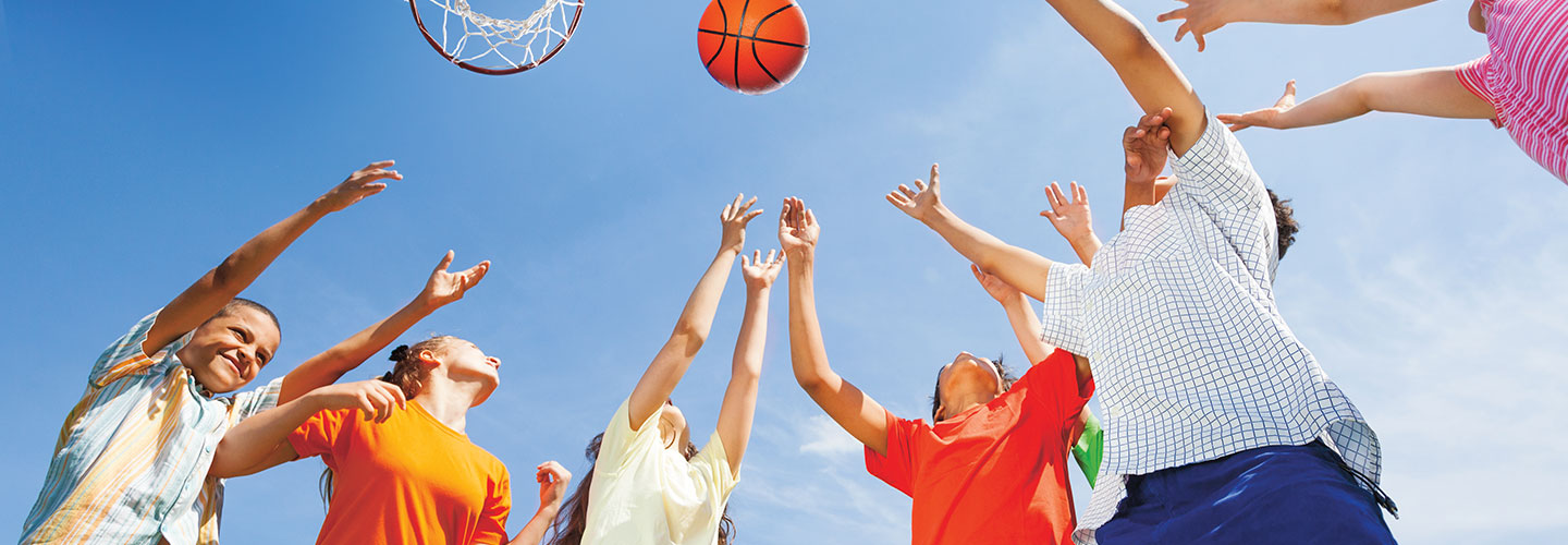Image of students playing basketball at recess